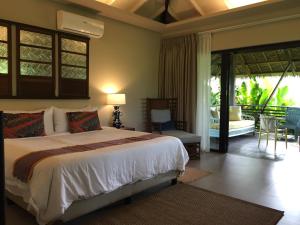 Postel nebo postele na pokoji v ubytování Kaimana Resort Siargao