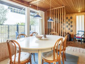 a dining room with a table and chairs at Holiday home Frørup VI in Frørup