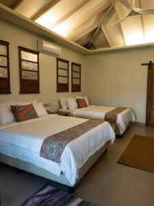 Postel nebo postele na pokoji v ubytování Kaimana Resort Siargao