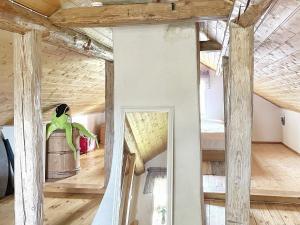 a room with wooden ceilings and a large mirror at Holiday home GÖTENE II in Götene