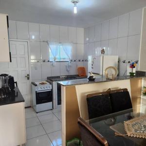 a kitchen with a stove and a counter top at Casa Recanto de Unamar in Cabo Frio