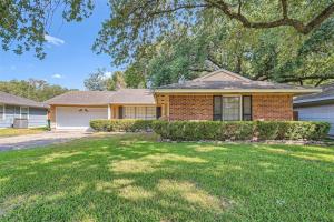 a brick house with a tree in the yard at Elegant 3BR Bungalow Oasis plus Pool in Prime Locations in Houston