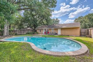 a swimming pool in the yard of a house at Elegant 3BR Bungalow Oasis plus Pool in Prime Locations in Houston