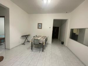 a dining room with a table and a tiled floor at D Nish Homestay in Tawau