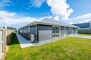 a house with a large yard with a building at Home away from home Methven in Methven