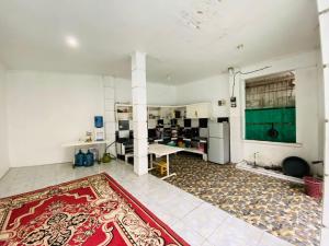 an empty room with a red rug on the floor at Villa Benny Gsp Cipanas in Cibadak