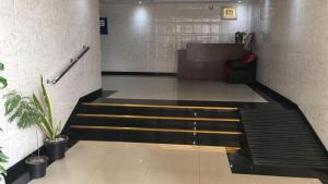a waiting room with stairs and a couch at Dubai NorthStar Hostels in Dubai