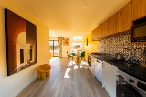 a kitchen with yellow walls and wooden floors at TekapoSpace in Lake Tekapo
