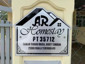 a sign for a house on a wall at AR HOMESTAY KUALA TERENGGANU in Kuala Terengganu