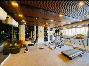 a gym with several treadmills and elliptical machines at 2 Bedroom Nice Location @ BTS onnut in Bang Chak