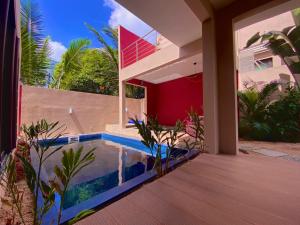 a house with a swimming pool in the backyard at Villa centre Grand Baie in Grand Baie