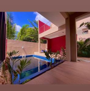 a house with a swimming pool in front of a house at Villa centre Grand Baie in Grand Baie