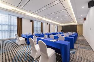 a conference room with blue tables and white chairs at Holiday Inn Express - Liuyang Development Zone, an IHG Hotel in Liuyang
