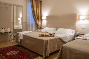 Postel nebo postele na pokoji v ubytování Hotel Ambasciatori