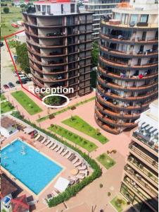 an aerial view of a building with a swimming pool at Super Lux Apartment Mgzavrebi in Gonio