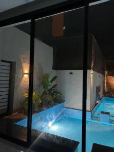 a large swimming pool in a building with a swimming pool at شاليه بلاك وايت in Al Harazat
