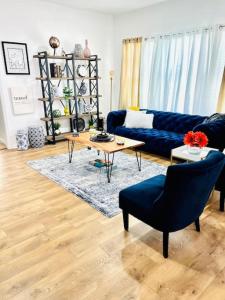 a living room with a blue couch and a table at Group Stay 3bd 2bth Ask about Deals in Birmingham