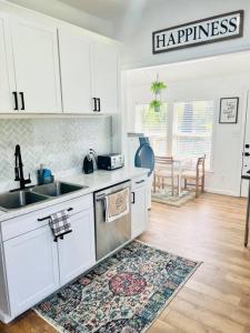 a kitchen with white cabinets and a sink and a kitchen rug at Group Stay 3bd 2bth Ask about Deals in Birmingham