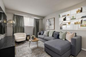 a living room with a gray couch and a chair at Maple Heights Gem Libby Unit 1 in Maple Heights
