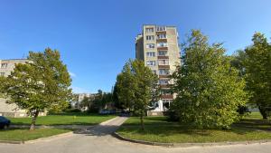 a tall apartment building with trees in front of it at C3 apartment in Kėdainiai in Kėdainiai