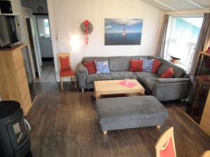 a living room with a couch and a table at Ferienhaus Johns Holthuus in Brodersby
