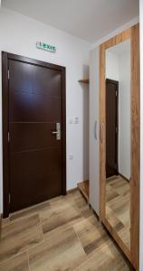 a large door in a room with a mirror at M&A Apartmani in Vrdnik