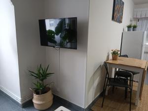 a room with a table and a tv on the wall at La Campanilla-Suances in Suances