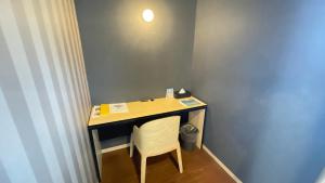 a desk with a chair in a room at BiBi Hotel Conventionbay in Ginowan