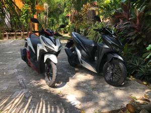 two motorcycles parked next to each other on a street at The Hill Village in Thong Nai Pan Noi