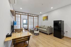 22housing Residence Suites في هانوي: غرفة معيشة مع أريكة وطاولة