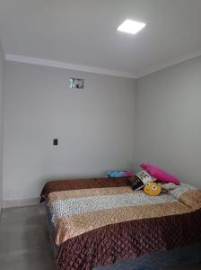 a bedroom with a bed with two items on it at Casa de lazer km eventos in Uberaba