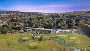 an aerial view of a mansion with a golf course at Park Proxi Gibraltar Bowral in Bowral