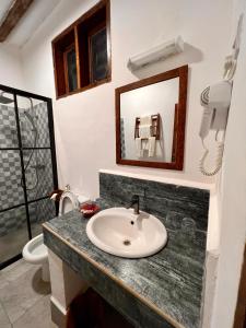 a bathroom with a sink and a mirror at Zanzibar Bahari Villas in Matemwe