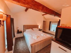a bedroom with a bed and a flat screen tv at Ye Olde Original Withy Trees in Bamber Bridge