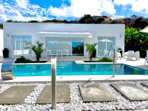 a villa with a swimming pool in front of a house at Casa Ortega in Los Llanos de Aridane +29 photos