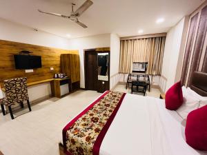 a hotel room with a bed and a television at Ashoka International Hotel - Karol Bagh New Delhi in New Delhi