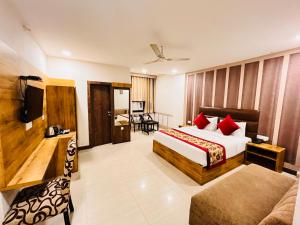 Ashoka International Hotel - Karol Bagh New Delhi في نيودلهي: غرفه فندقيه بسرير واريكه