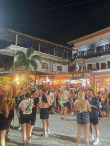 a crowd of people standing in a street at night at Revolution Koh Tao in Koh Tao