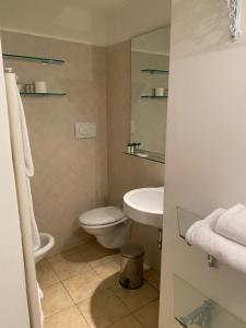 a bathroom with a toilet and a sink at Borghese Palace Art Hotel in Florence