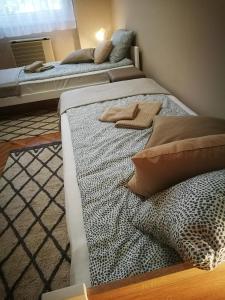 two beds sitting next to each other in a room at Fontana Apartman in Makó