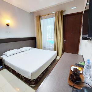 Postel nebo postele na pokoji v ubytování Sangga Buana Resort & Convention Hotel