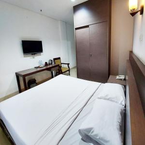 Postel nebo postele na pokoji v ubytování Sangga Buana Resort & Convention Hotel