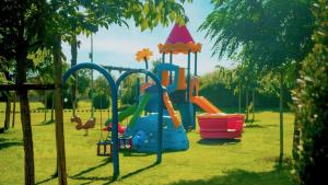 a playground with a slide in a park at Gitavillage California in Montalto di Castro