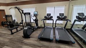 a gym with several treadmills and elliptical machines at Beartooth Hideaway Inn & Cabins in Red Lodge