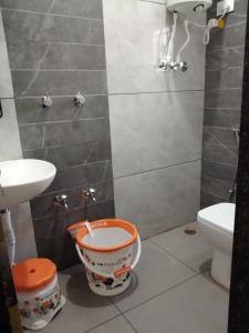 een kleine badkamer met een toilet en een emmer bij ESHANNA RESIDENCY in Davangere