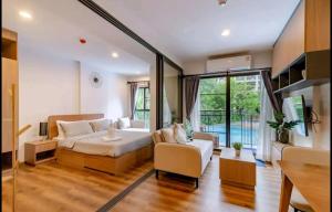 a living room with a bed and a couch at LAHABANA Resort in Hua Hin +44 photos