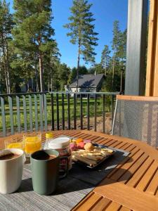 a table with a tray of food on top of a table at Cosy apartment with a balcony by the sea. in Ķesterciems