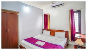 - une chambre avec un lit et une fenêtre dans l'établissement Noel Apartments, à Cochin