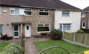 a house with a fence and a yard at Havenwood House - Serene Escape Cottage in Nottingham