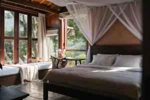 a bedroom with a large bed and a window at Lily’s Home & Retreat - Venue Travel in Tien Xuan